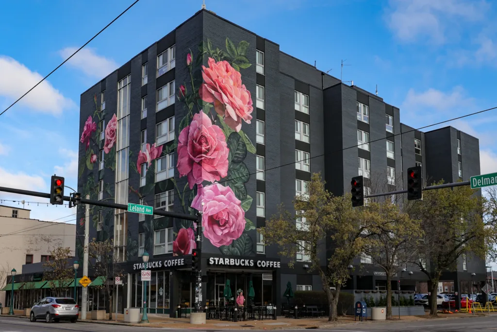Large floral mural covering the exterior of a building above the Starbucks coffee shop in the Delmar Loop.