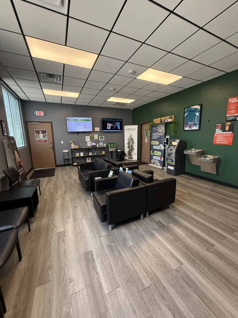 NatureMed's waiting area features comfortable seating, educational resources, and digital menu displays for customers.