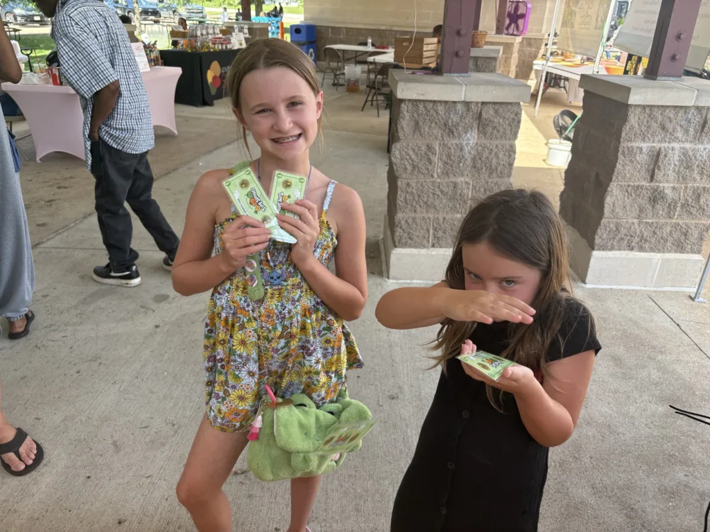 Ferguson Farmers' Market's Tiny Sprouts program pays kids to explore the market and try new produce.
