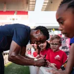 After the match, CITY2 players take time to connect with fans and sign autographs.