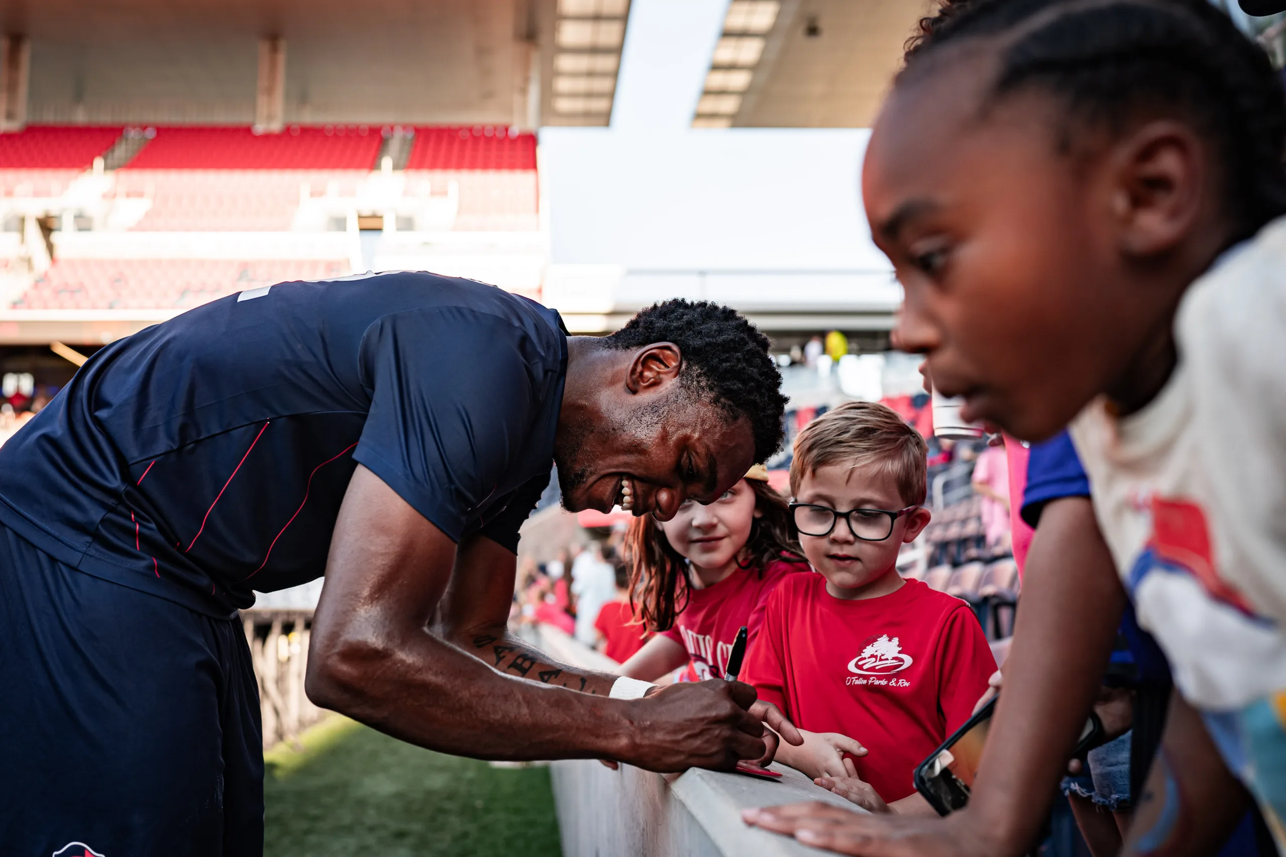 After the match, CITY2 players take time to connect with fans and sign autographs.