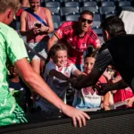 After the match, CITY2 players take time to connect with fans and sign autographs.