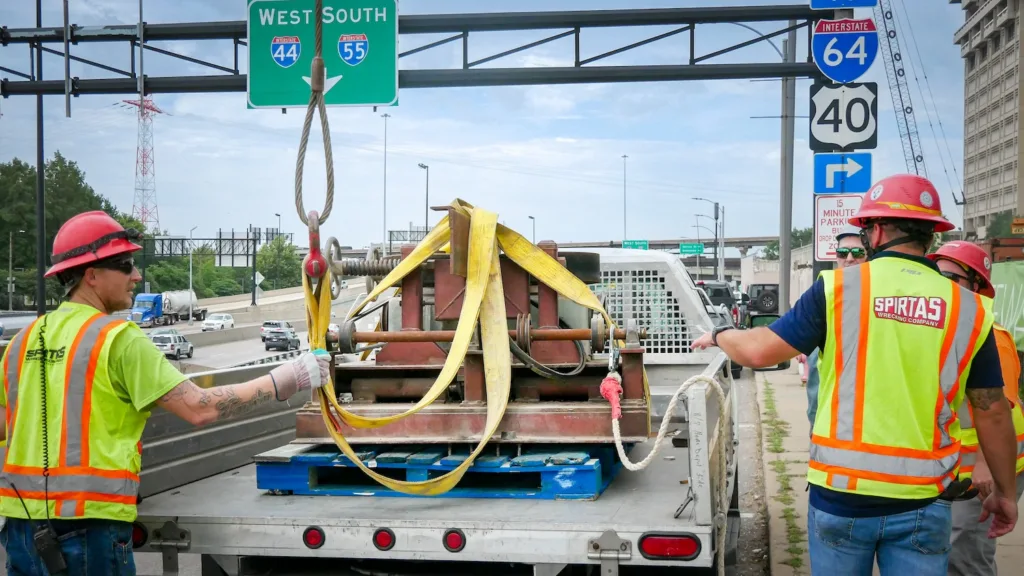 An axle is secured on the back of a truck.