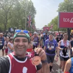 Scott MacArthur celebrates completing the 2026 TCS London Marathon.