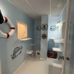 Cats can enjoy a seaside-inspired stay in this nautical-themed suite complete with climbing shelves and cozy hideaways.