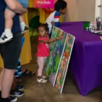 Child choosing face paint design