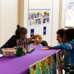 Child sitting patiently while getting face paint done