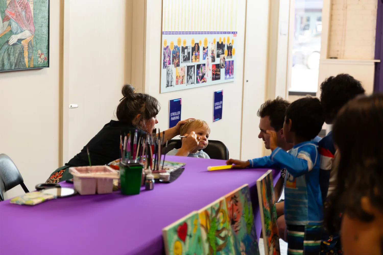 Child sitting patiently while getting face paint done
