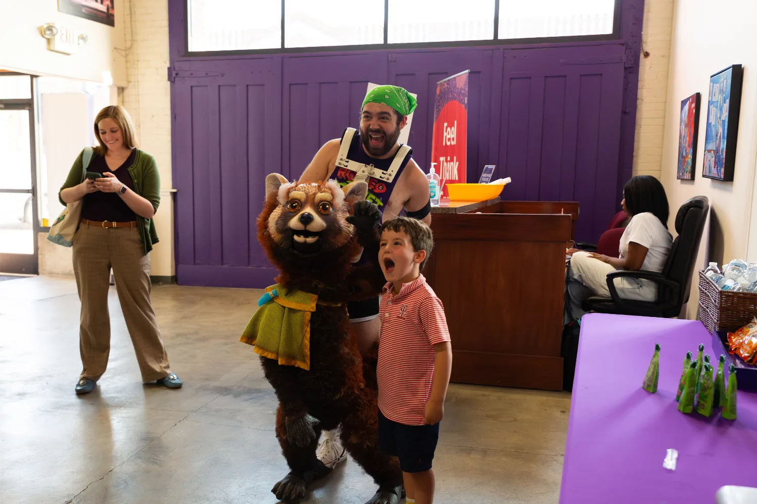 Child posing for a picture with the Romeo & Zooliet puppet