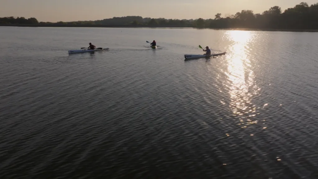 Kayakers paddle across the calm waters of Binder Lake, a favorite destination for outdoor recreation.