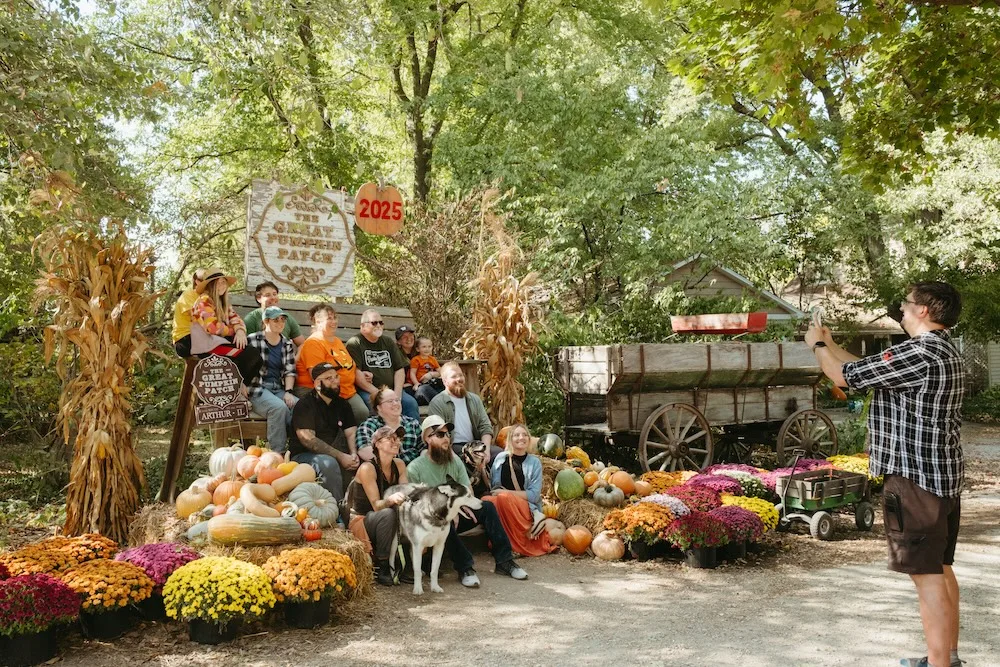 Visitors gather for a fall photo at The Great Pumpkin Patch in Arthur, Illinois.
