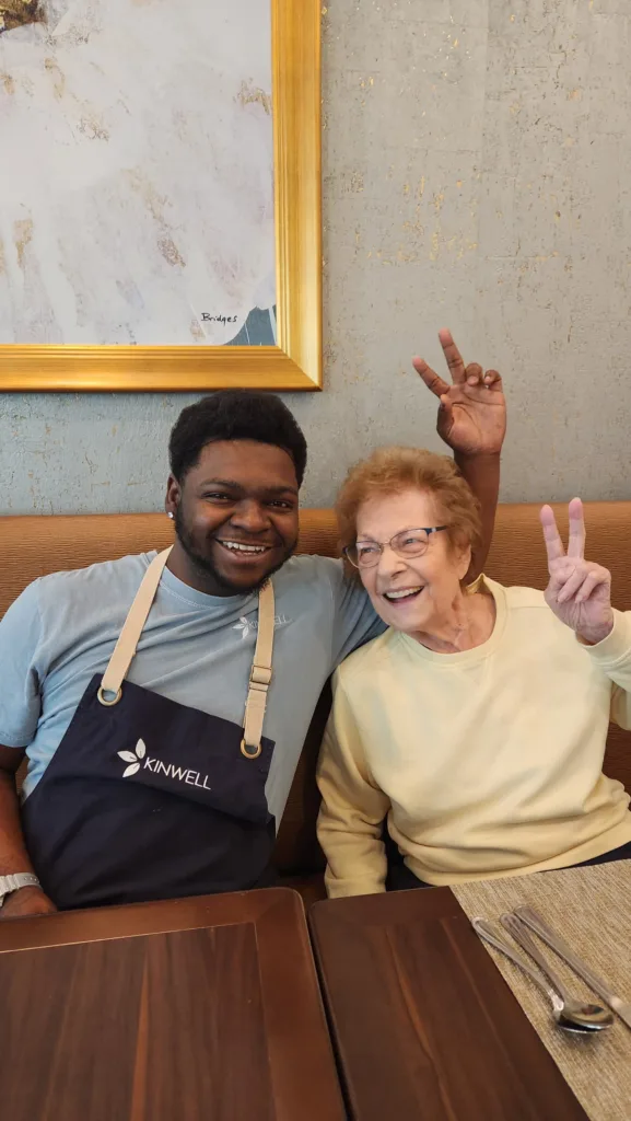 A Kinwell team member and resident share a lighthearted moment together.