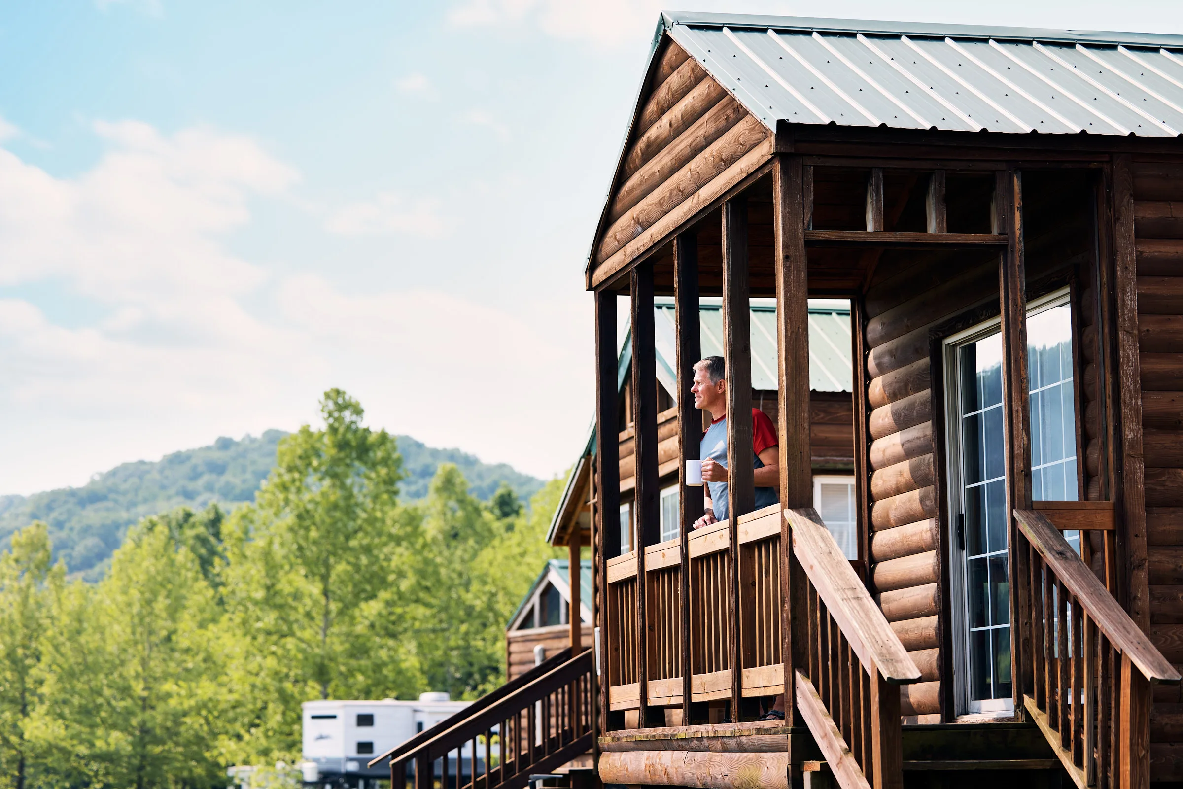 Guests can enjoy peaceful mornings on the porch of their cabin, surrounded by the beauty of the Ozarks.