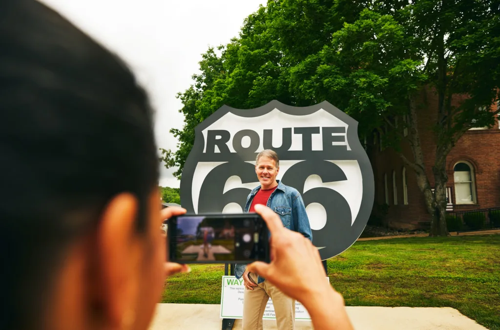 Travelers capture a photo at Pulaski County's iconic Route 66 shield