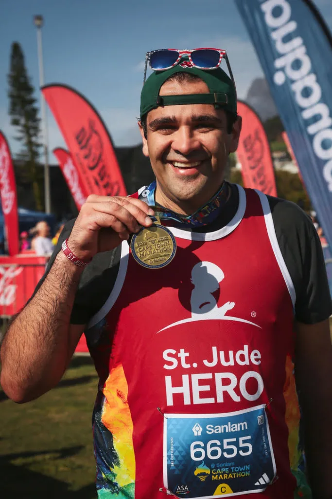 Scott MacArthur celebrates after completing the Cape Town Marathon