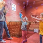 Families enjoy an interactive exhibit at the Customs House Museum.