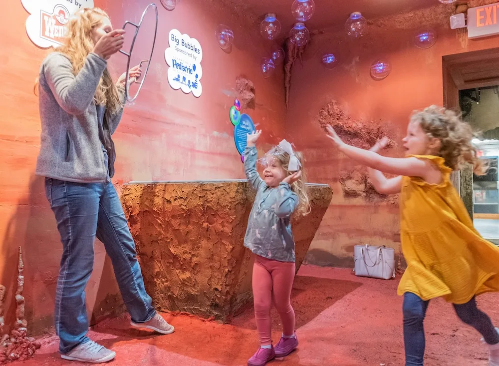 Families enjoy an interactive exhibit at the Customs House Museum.