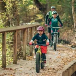 A family enjoys cycling and exploring the trails at Rotary Park.