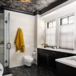 An in-wall toilet conceals the tank behind the wall, helping save valuable floor space while creating a streamlined look.