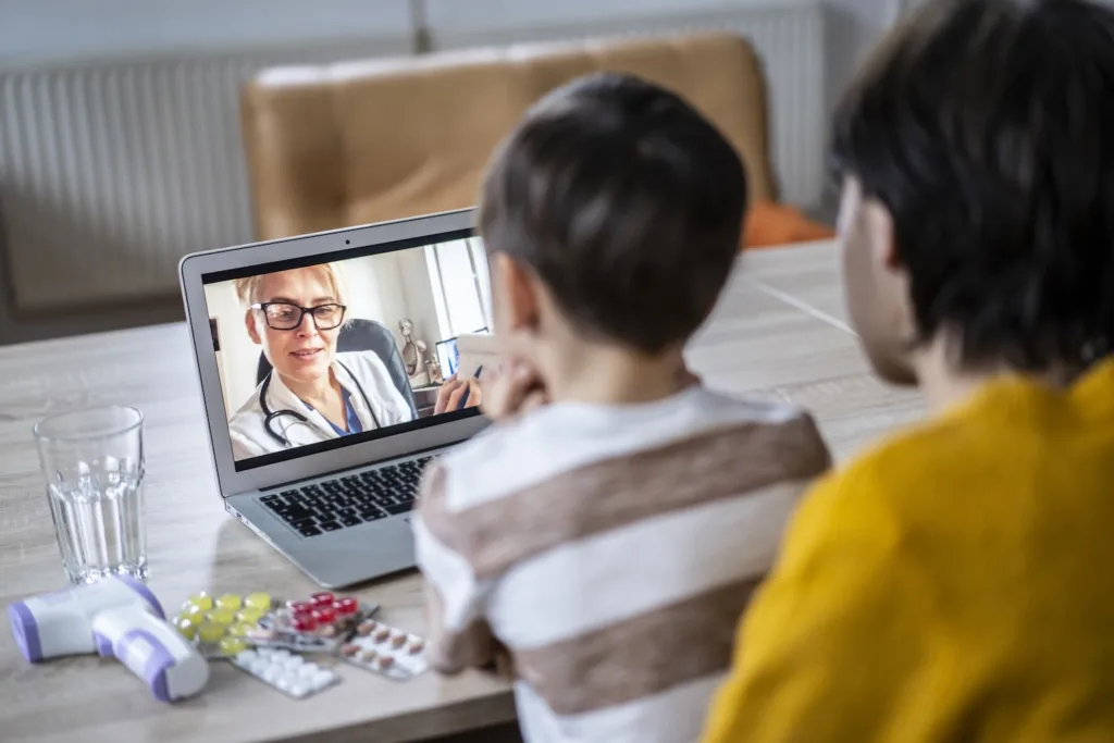 mom and kid having video call with doctor