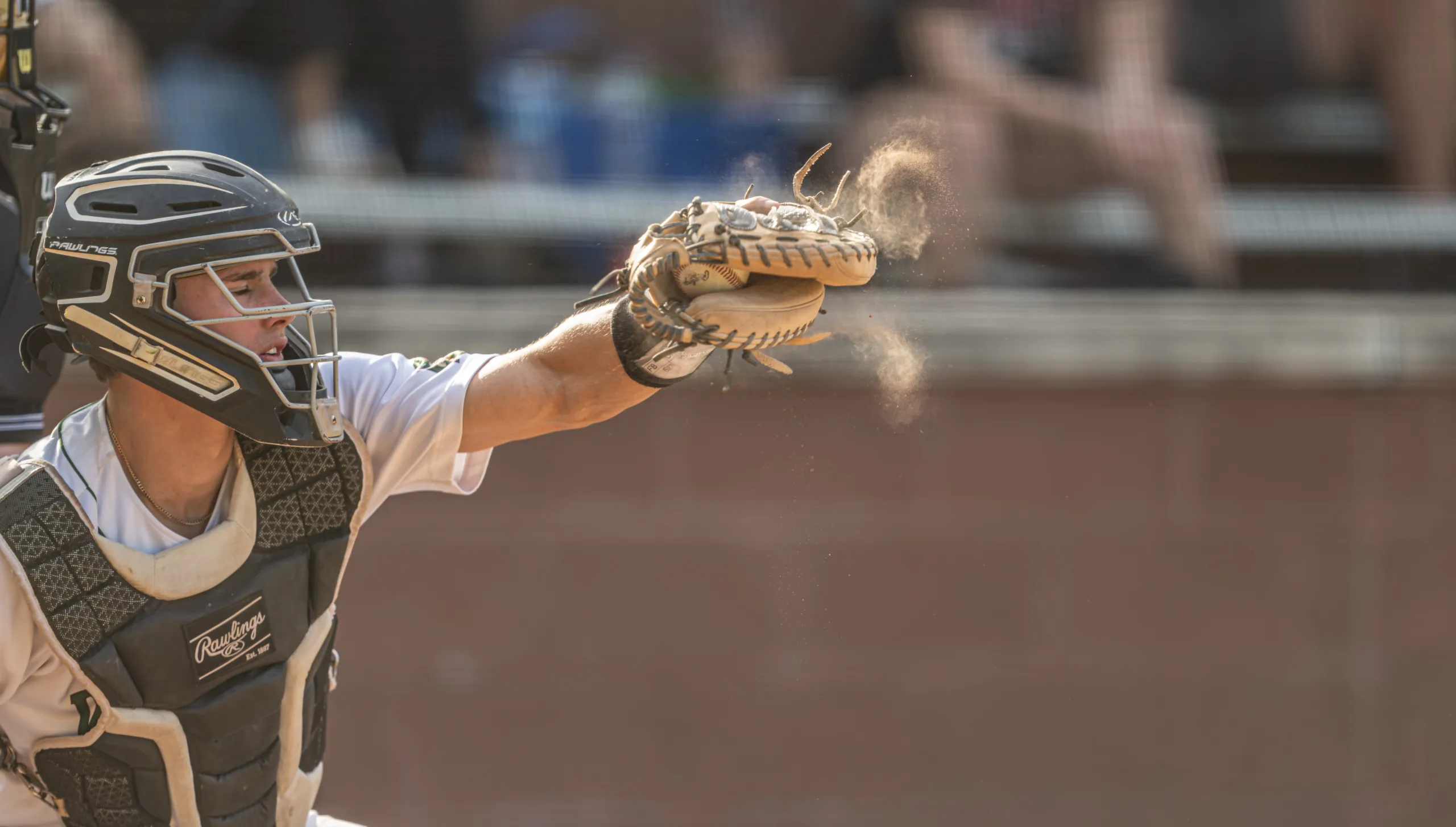 A Whitfield varsity baseball player makes a catch behind the plate.