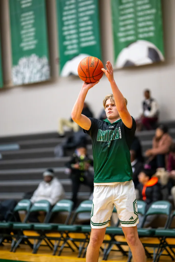 A Whitfield varsity basketball player warms up before a game.
