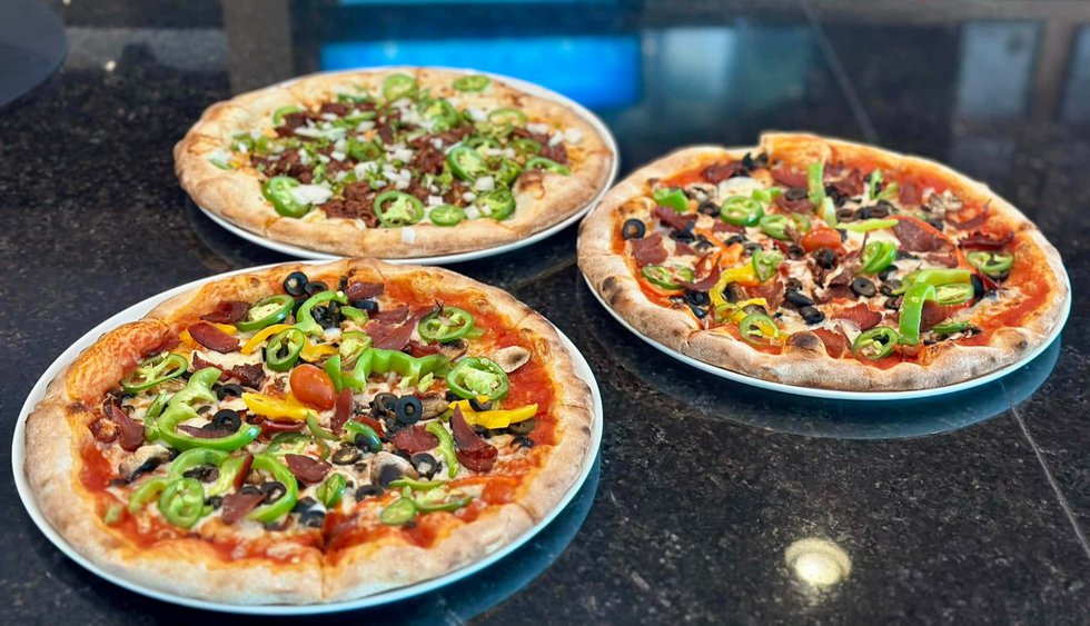 2%20birria%20pizzas%2C%20foreground%2C%20Eni%27s%20special%20pizza%20with%20gyro%20meat%20in%20background%202.jpg